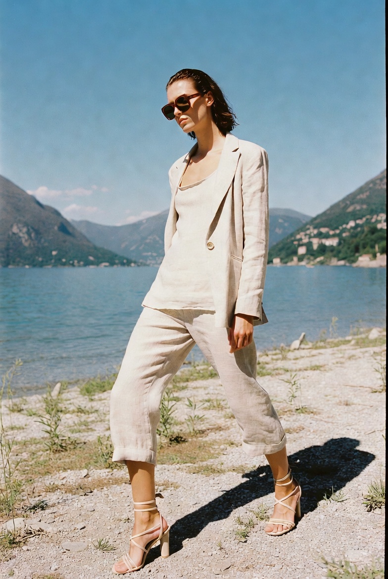 A woman in cropped capri linen trousers and a top at Lake Como, ESVRA Power of Linen edit