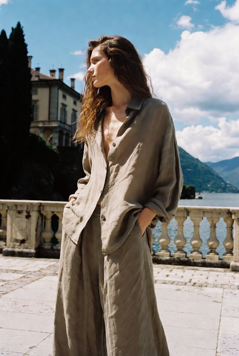 A woman in wide linen trousers and a shirt at Lake Como, ESVRA Power of Linen edit