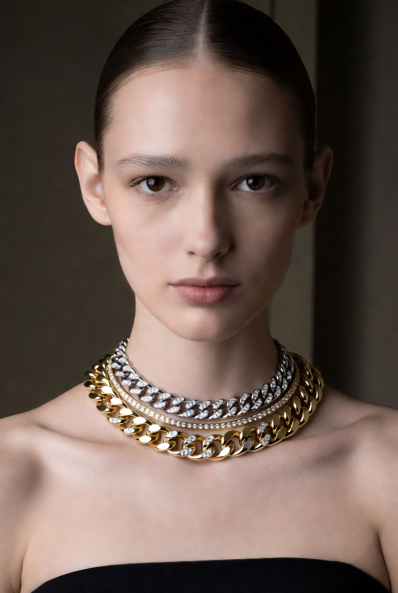 A model wearing layered fine gold and diamond necklaces